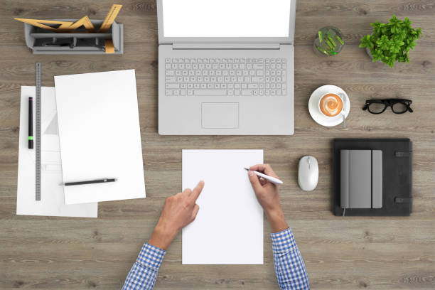 istock Man writing on a blank piece of paper, copy space template - top view 994842350
