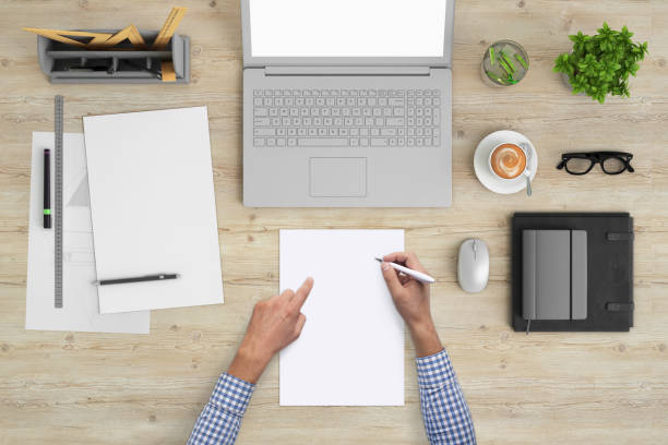 istock Architect writing on a blank piece of paper, copy space template - top view 994842356