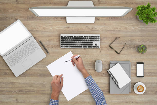 istock Man writing on a blank piece of paper, copy space template - top view 994842380