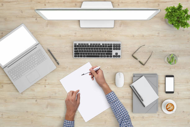 istock Man writing on a blank piece of paper, copy space template - top view 994842392