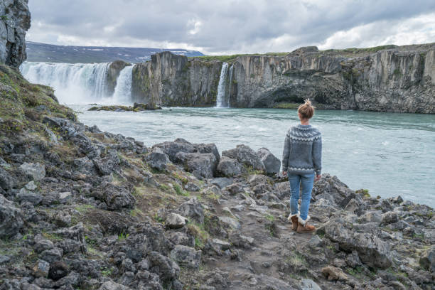 istock Young woman contemplating waterfall in Iceland 994845332