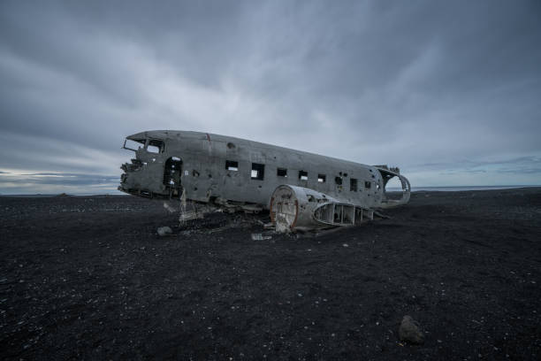 istock Airplane wreck against dramatic sky on beach Iceland, DC3 navy plane 994850296