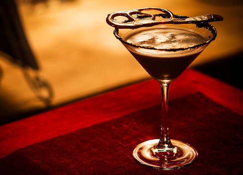 chocolate caramel cream martini mixed cocktail glass inside cozy bar