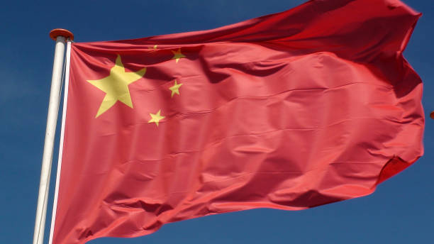 istock Chinese National Flag Waving Against Sky View During The Day 994857294