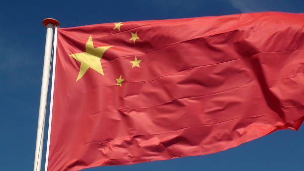 istock Chinese Flag Waving Against Blue Sky 994857350