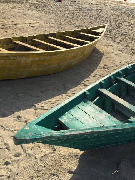 istock Three colorful boats on sand 994860090