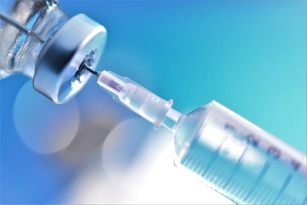 istock syringe needle injected into drug bottle 994866840