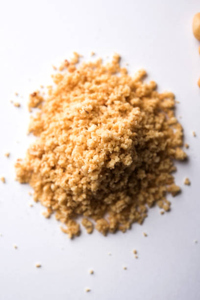 istock Crushed peanuts or mungfali powder with whole and roasted groundnut. Served in a bowl over moody background. Selective focus 994866854