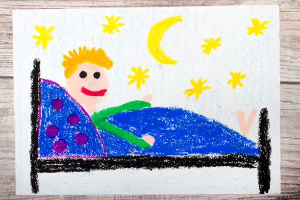 Colorful hand drawing and crayons: smiling little boy lying in a bed. Sleeping time