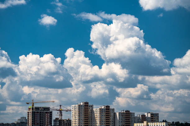 istock Summer landscape of building city and blue sky clouds 994875384