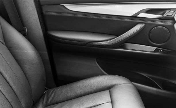 istock Car inside. Interior of a car. Comfortable leather Black seats. Black perforated leather. Car interior details. Car detailing 994876136