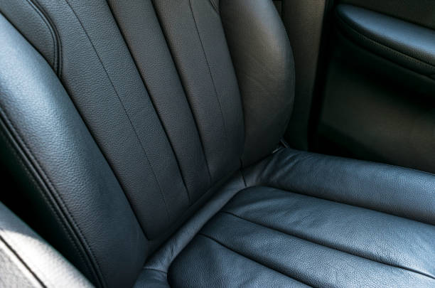 istock Car inside. Interior of a car. Comfortable leather Black seats. Black perforated leather. Car interior details. Car detailing 994878014