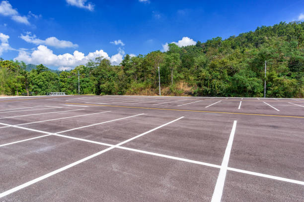 istock Empty parking lot with forest and beautiful blue sky. 994881892