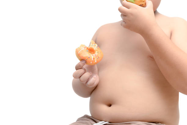 istock Obese fat boy is holding donut isolated 994887854