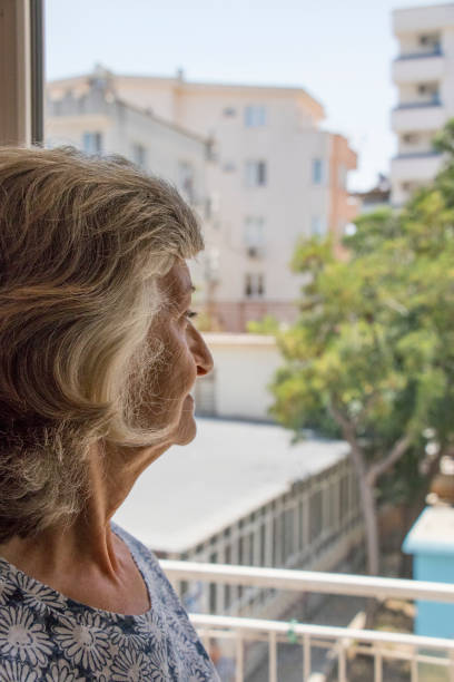 istock Beautiful woman looking away from the window 994888040