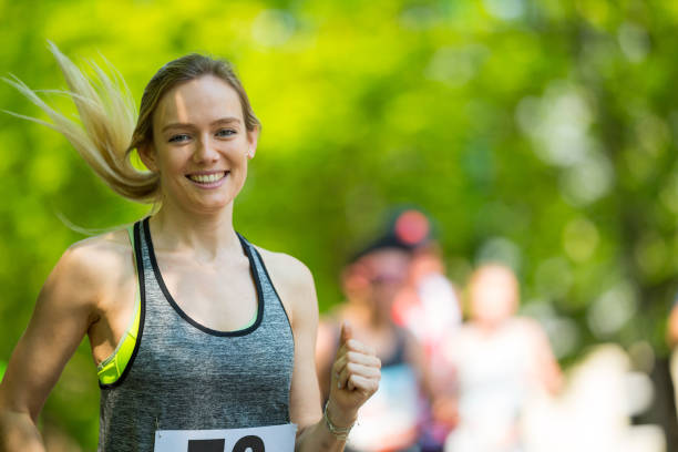 istock smiling fit woman running marathon 994890836