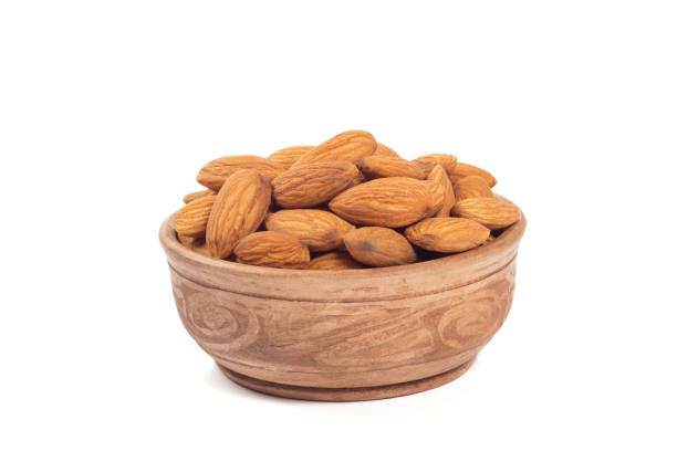 istock Almond nuts  in brown cup isolated on the white background 994918492