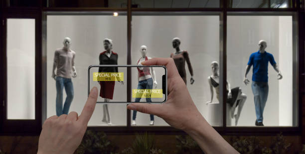 Augmented reality marketing concept. Hand holding digital tablet smart phone use AR application to check special sale price in retail fashion shop, mall interior design