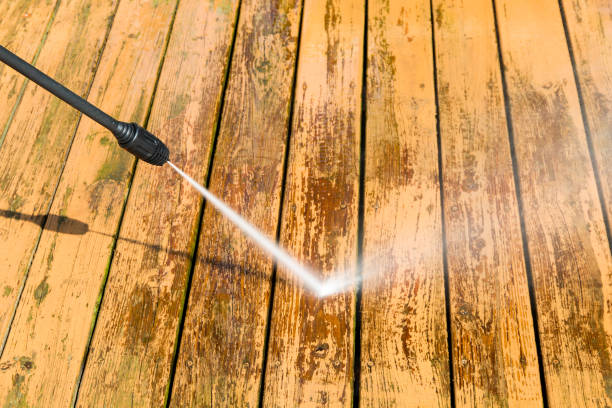 Power washing. Wooden deck floor cleaning with high pressure water jet. stock photo