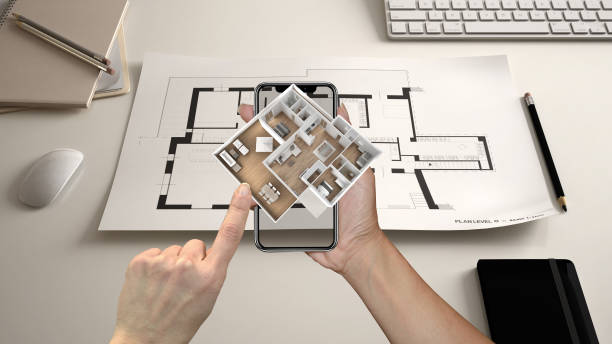 istock Augmented reality concept. Hand holding smartphone with AR application used to simulate 3d pop-up interactive house maps to life 994921264
