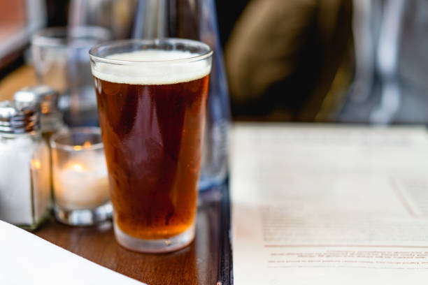 istock IPA beer next to a window at a rustic bar next to a menu 994933948