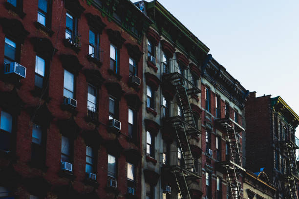 istock Dark New York style buildings with fire escapes 994934036