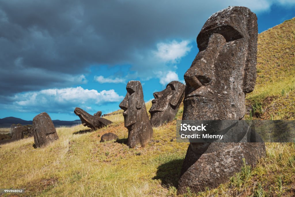 Easter Island Rano Raraku Moai Statues Rapa Nui Chile Rano Raraku Moai Statues Easter Island under blue sunny summer sky. Edited Colors. Rano Raraku, Rapa Nui National Park, Hanga Roa, Easter Island, Isla de Pascua, Polynesia, Chile, Oceania Valparaiso - Chile Stock Photo