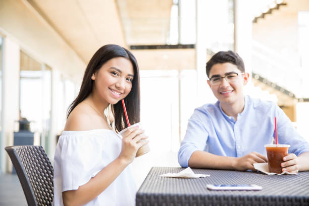 istock Couple Having Refreshing Drinks At Table In Shopping Mall 994953862