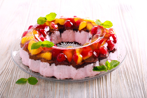 Jelly topping layered yogurt ring cake on plate
