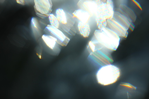 Abstract background of blue luminous rays and lens flare.