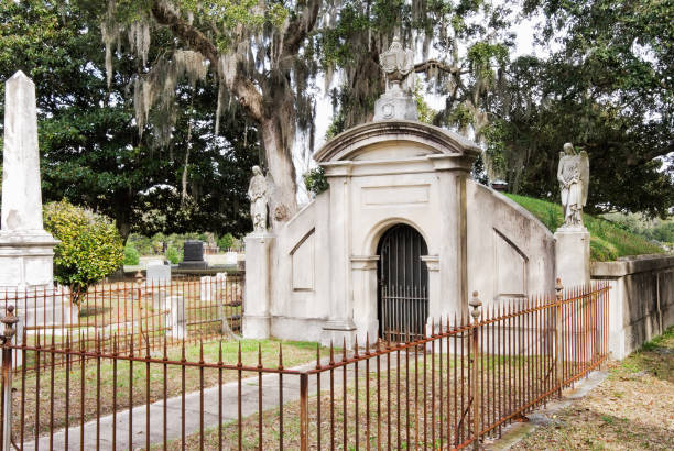 Mausoleum at Magnolia Cemetery in Charleston South Carolina Above ground mausoleum grave at historic Magnolia Cemetery in Charleston South Carolina. An old oak tree with moss hanging from its branches is in the background. mausoleum stock pictures, royalty-free photos & images