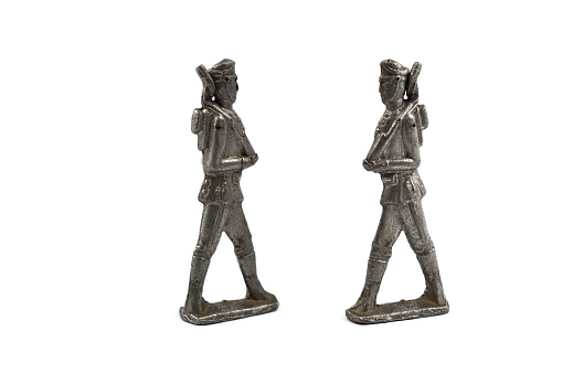 Old tin soldier on a white background. Two tin soldiers
