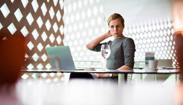 istock Businesswoman drinking coffee in modern office. 994987488