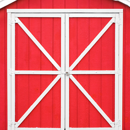 Classic red barn style door with white trim.