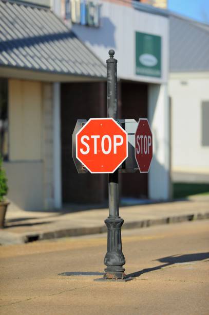 istock Four way stop sign in middle of town intersection 995010678