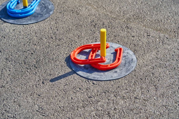 istock Horse shoes game in the asphalt 995019480