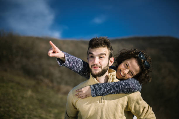 istock Young man carrying a friend on his back. 995019842