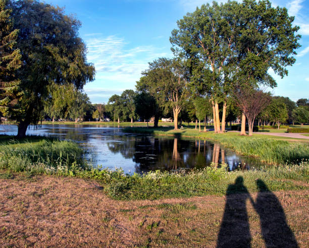 Togetherness Couple in Silhouette at magic hour lighting in a beautiful park setting.