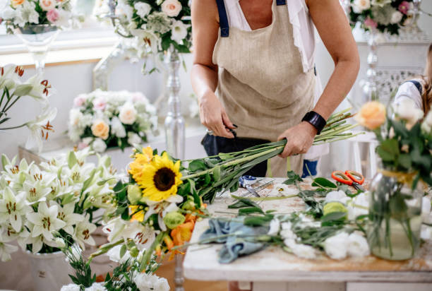 Florist making floral arrangement stock photo