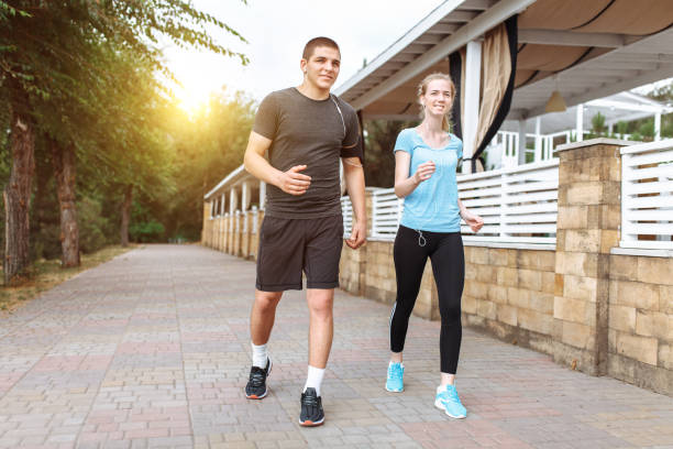 istock morning running in men and women, training before work, two people athletes 995043644