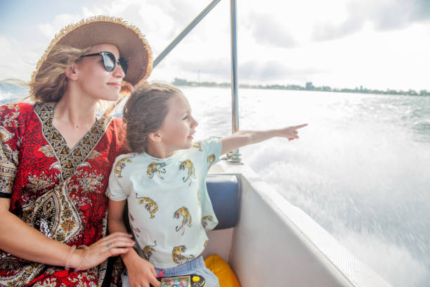 Woman and Little Girl on a Boat Trip Woman and Little Girl on a Boat Trip, Girl Pointing at Something family motorboat stock pictures, royalty-free photos & images