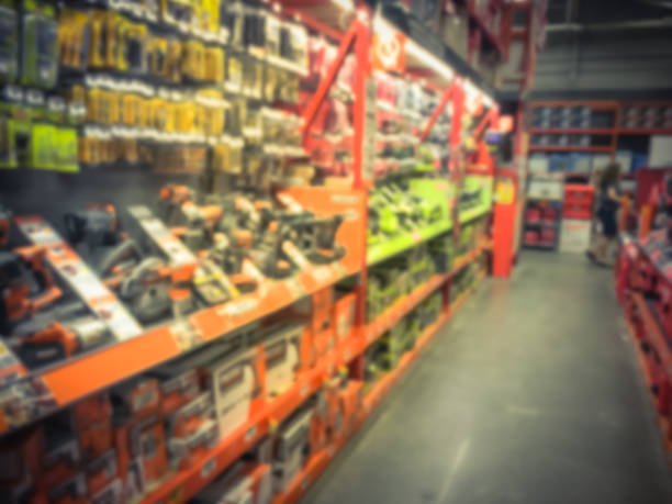 istock Vintage blurred power tool combo kits at hardware store in America 995076696