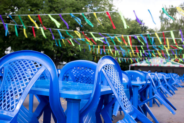 empty blue plastic chairs and tables outside, preparing for the holiday, no people