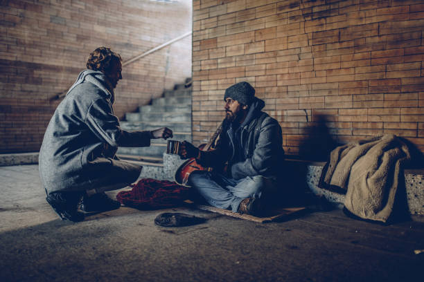 Woman Giving Money To Beggar Man Woman Giving Money To Beggar On Street homelessness stock pictures, royalty-free photos & images