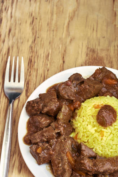 istock Plate with meat and liver under sauce with rice 995102672