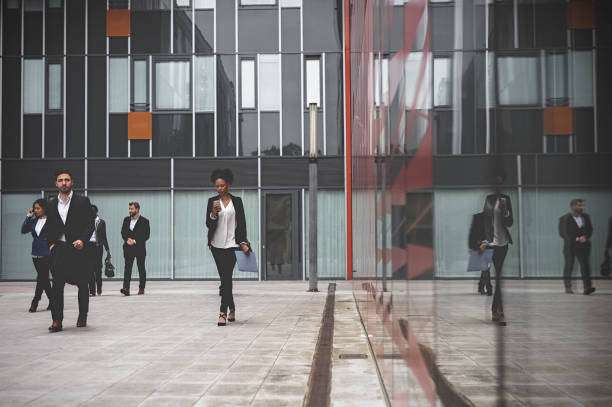 istock Business people walking downtown business district 995104746