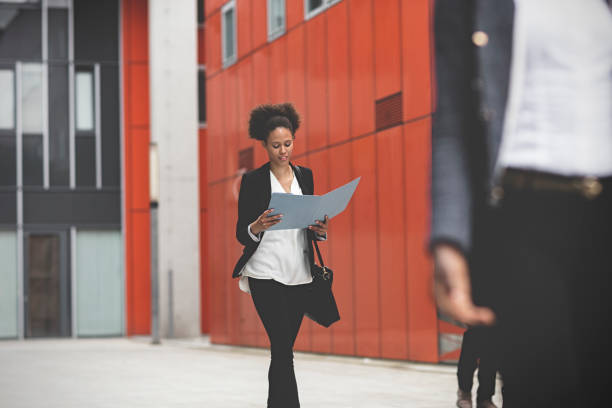 istock Business woman walking downtown business district 995104970