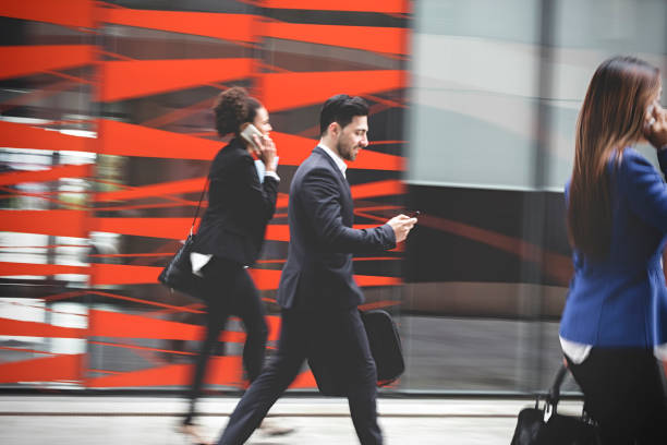 istock Business people walking downtown business district 995107174