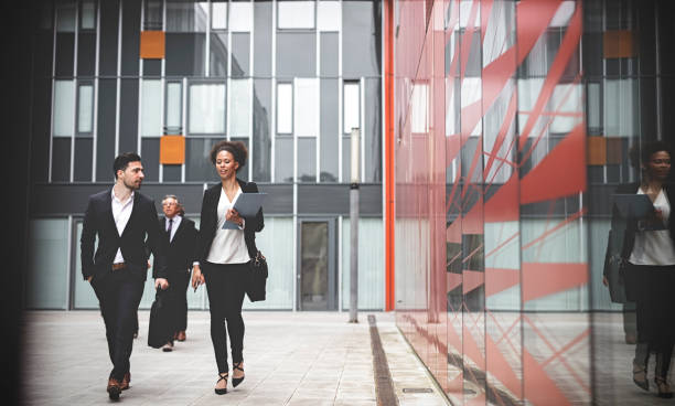 istock Business people walking downtown business district 995107198