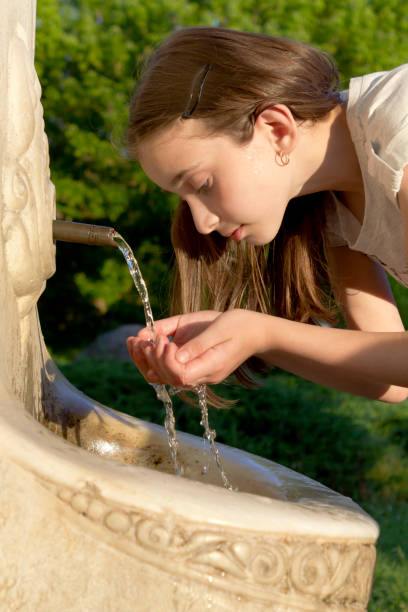 istock Young girl drinking water 995116606